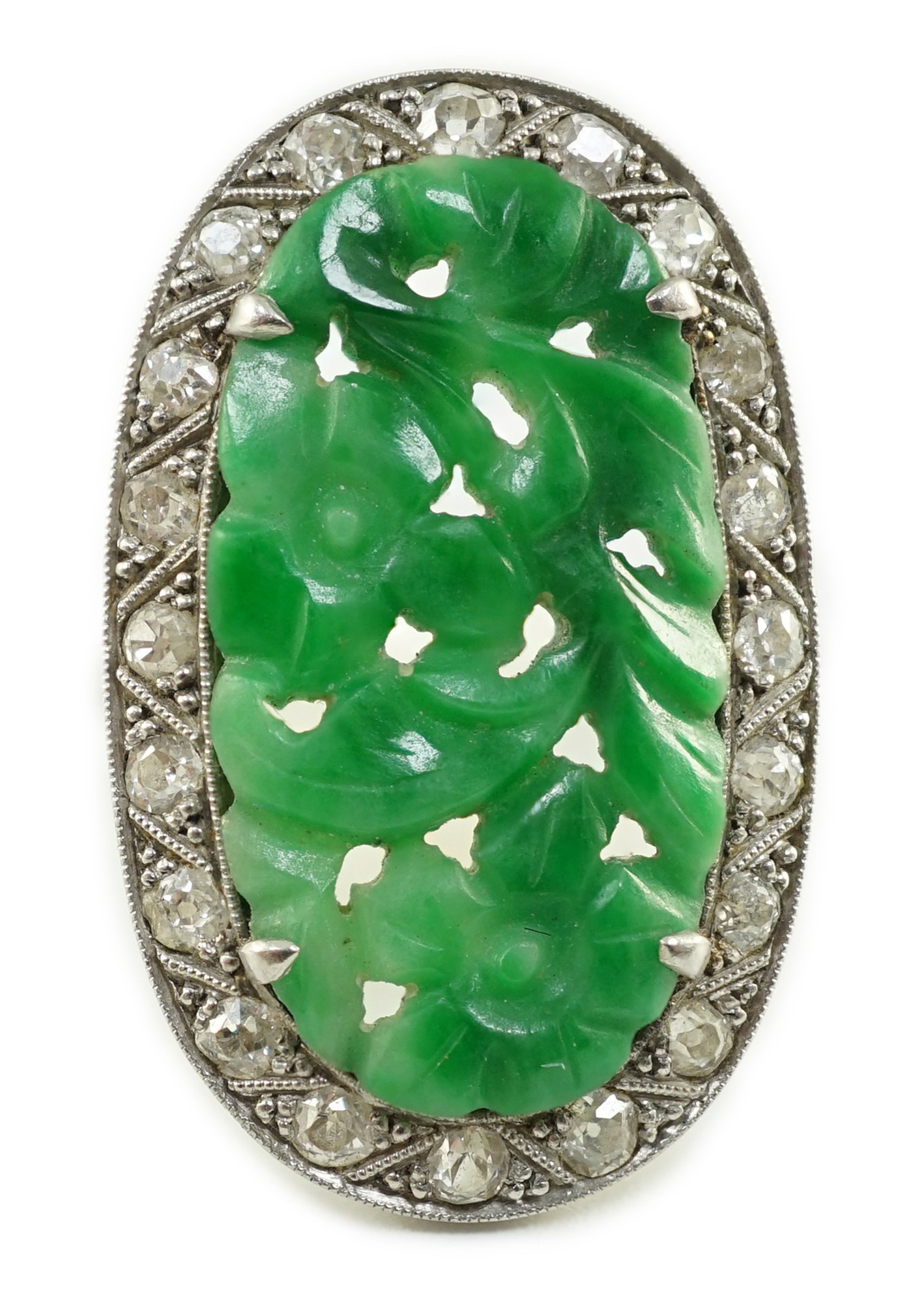 A 1920's/1930's white gold, jadeite and diamond set oval dress ring